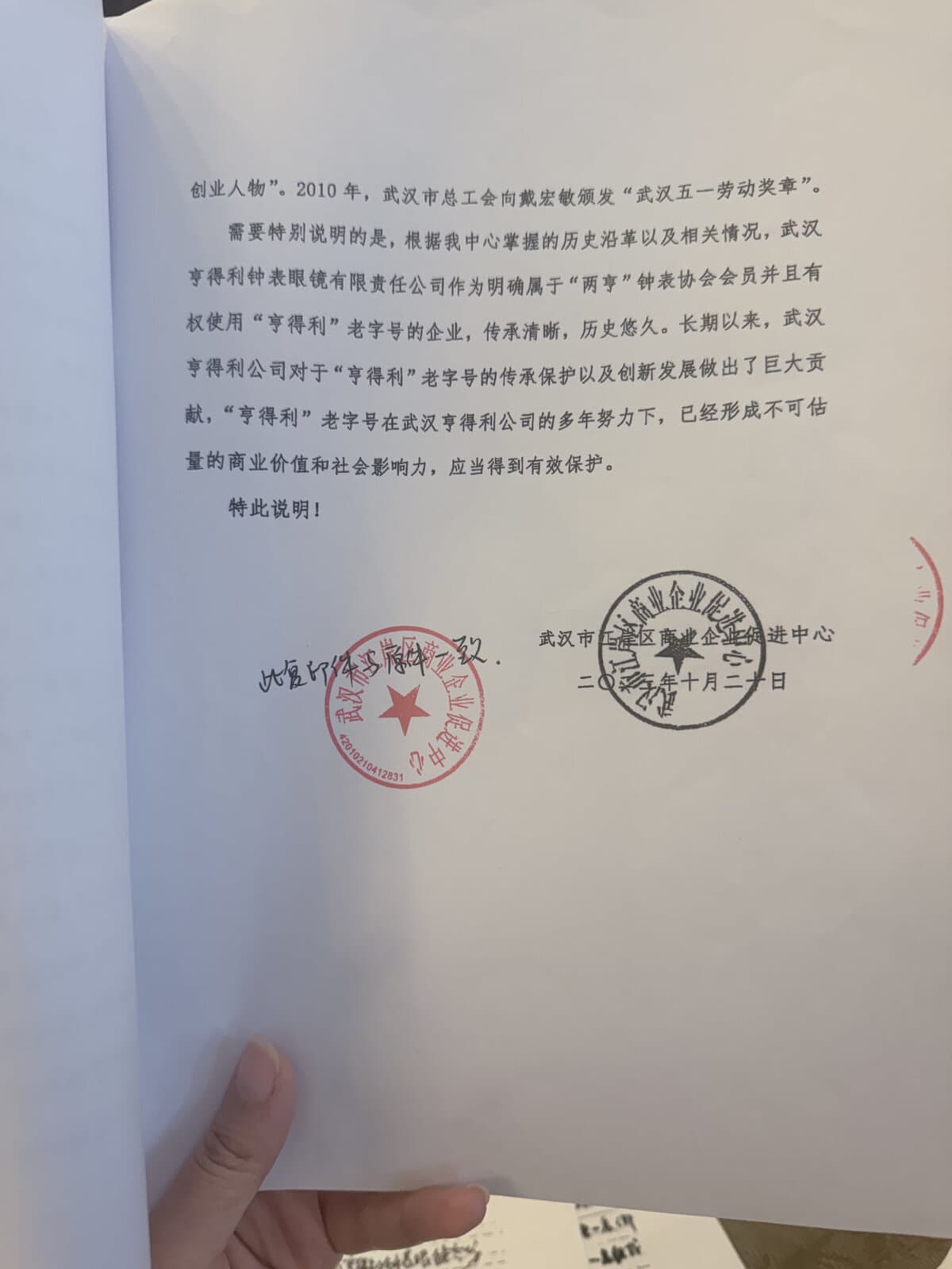 武汉市江岸区商业企业促进中心2023年出具的武汉亨得利钟表店情况说明第3页及落款印章